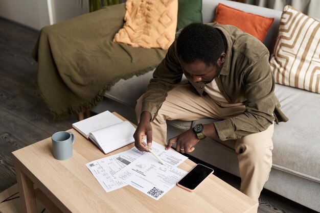 black man doing taxes home filling out documents 236854 55030