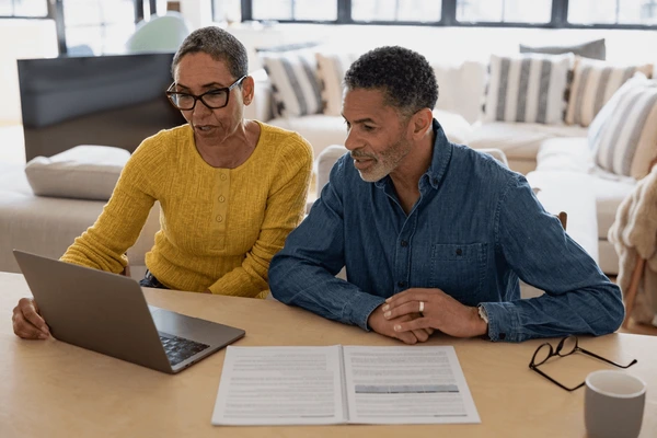 senior couple looking paperwork using 600nw 2626925993